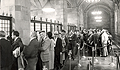 Before the electronic transfer of information, a Treasury auction at the Bank involved individuals waiting in line at the first floor cages of the Bank to purchase U.S. securities.   Today, this space is used for an array of public gatherings.  (c. 1970)
